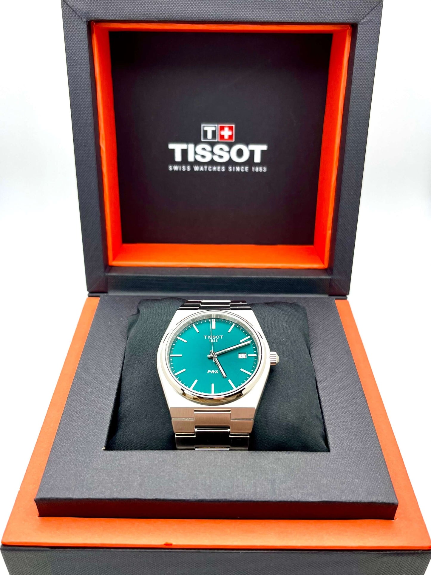 Tissot PRX Quartz T137.410.11.091.00 40mm stainless steel men’s watch with green dial, date display, sapphire crystal, and 100m water resistance